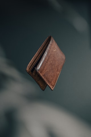 Slim leather wallet photographed with rich contrast